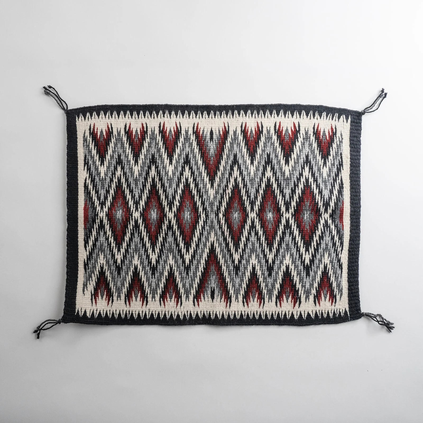 Red "Diamond Pattern Eye Dazzler" Navajo weaving, by Ivan Catron by Karen Domenici.