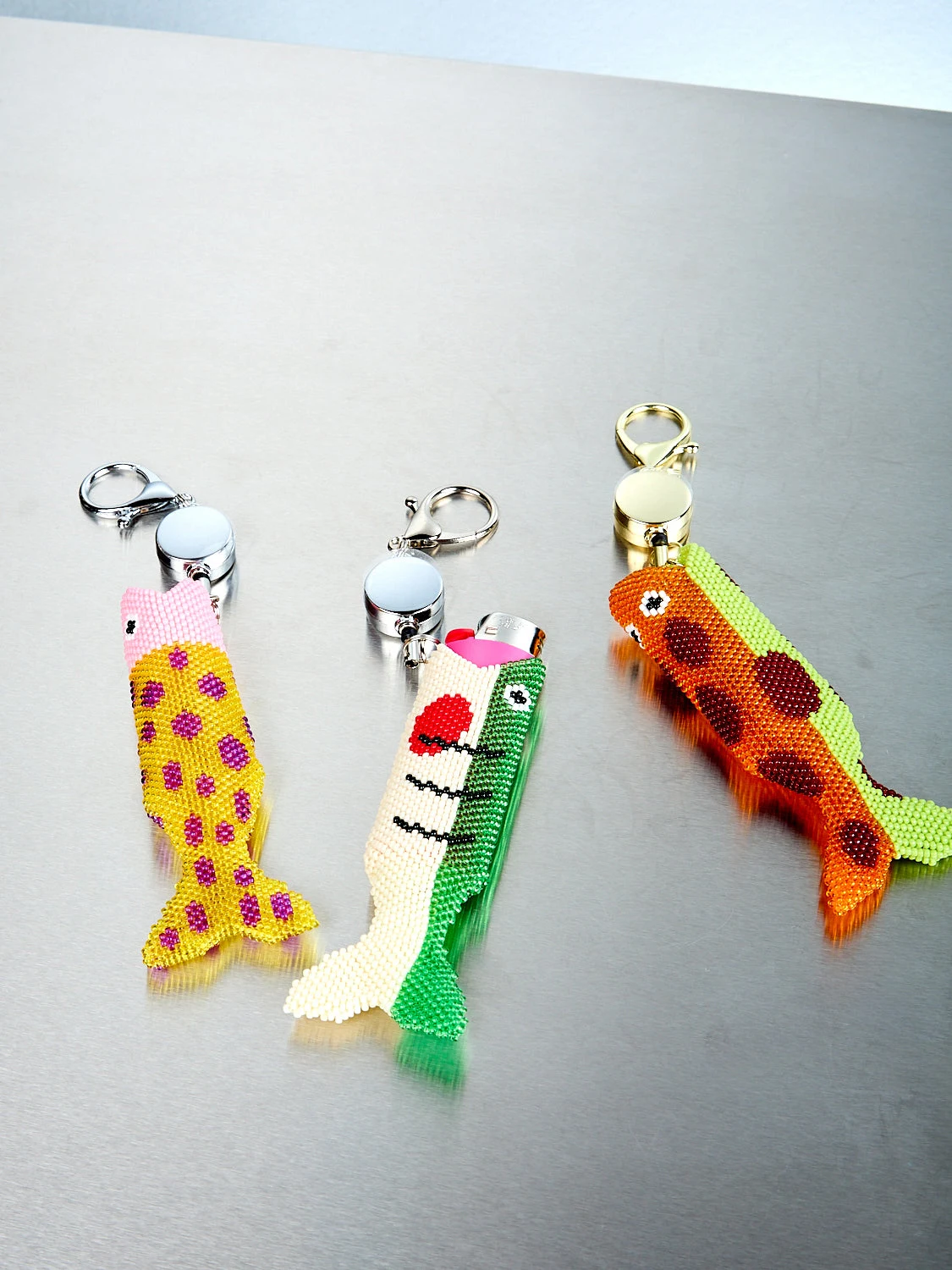 Beaded Fish Lighter Holder by Edie Parker.