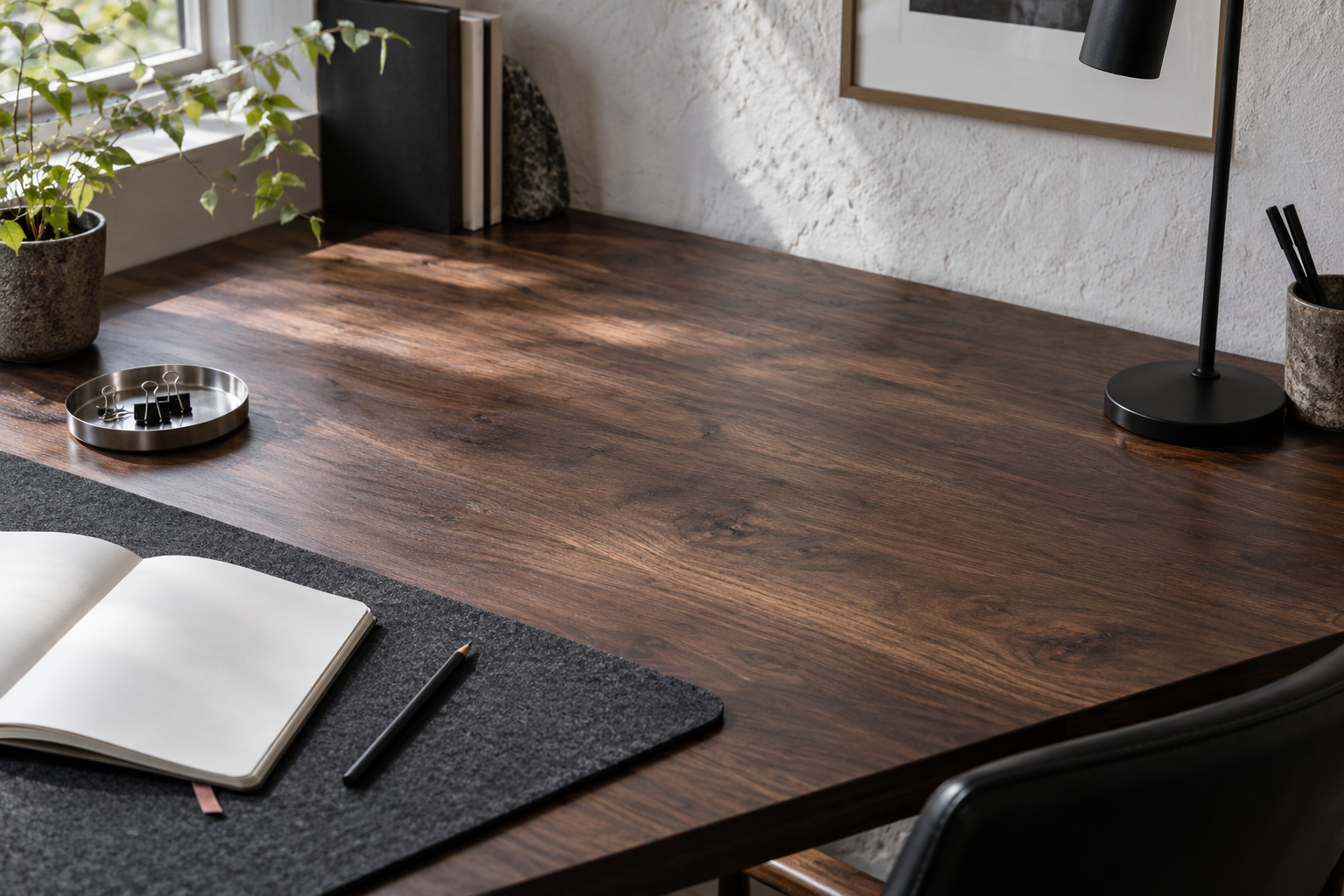 AI-generated conceptual image: A wooden desk holds a charcoal mat, blank notebook, small metal tray and lamp beside a bright window.