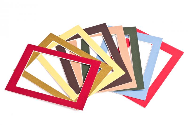 Several rectangular window mounts in different colours overlap on a white surface.